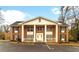 Classic brick exterior of a residential building featuring stately columns and well-maintained landscaping for a welcoming curb appeal at 135 E Hill St # 24, Decatur, GA 30030