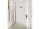 A secure white front door with a keypad, showing modern access and security in the entryway at 135 E Hill St # 24, Decatur, GA 30030