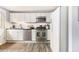Modern kitchen featuring white cabinets, stainless steel appliances, and hardwood floors, offering a clean and efficient cooking space at 135 E Hill St # 24, Decatur, GA 30030