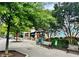 Inviting outdoor seating at Oakhurst Market, shaded by trees and featuring vibrant umbrellas at 135 E Hill St # 24, Decatur, GA 30030
