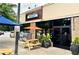 Oakhurst Market storefront with outdoor seating, potted plants, and a welcoming entrance at 135 E Hill St # 24, Decatur, GA 30030