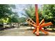 Public park featuring a large orange art sculpture, walking paths, and benches surrounded by greenery at 135 E Hill St # 24, Decatur, GA 30030