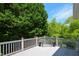 Back porch featuring gray floors, white railings, and views of mature trees at 2392 Ivy Mountain Dr, Snellville, GA 30078