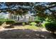 Backyard with mature landscaping, a deck, and lush green grass at 2392 Ivy Mountain Dr, Snellville, GA 30078