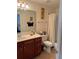 Bright bathroom featuring a single vanity, toilet, and shower with curtain at 2392 Ivy Mountain Dr, Snellville, GA 30078