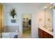 Bathroom featuring double sinks, cherry cabinets, and a walk-in closet at 2392 Ivy Mountain Dr, Snellville, GA 30078