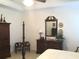 This bedroom features a four-poster bed and a matching armoire with crown molding at 2392 Ivy Mountain Dr, Snellville, GA 30078