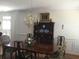 Traditional dining room with dark wood furniture, chandelier, and natural light at 2392 Ivy Mountain Dr, Snellville, GA 30078