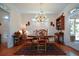 Dining room with hardwood floors, natural light, and a classic chandelier at 2392 Ivy Mountain Dr, Snellville, GA 30078