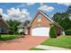Lovely brick home showcasing a driveway, two-car garage, and beautifully maintained green lawn at 2392 Ivy Mountain Dr, Snellville, GA 30078