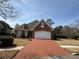 Beautiful brick home featuring a brick driveway and well-maintained lawn at 2392 Ivy Mountain Dr, Snellville, GA 30078