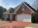 Charming brick home with a brick driveway and manicured landscaping at 2392 Ivy Mountain Dr, Snellville, GA 30078