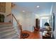 Spacious foyer showcasing hardwood floors, a staircase, and elegant decor leading into the home at 2392 Ivy Mountain Dr, Snellville, GA 30078