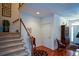 Inviting foyer with hardwood floors, staircase, coat closet, and elegant furniture at 2392 Ivy Mountain Dr, Snellville, GA 30078