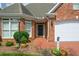 Inviting front entrance with brick walkway, manicured shrubs, and a classic black front door at 2392 Ivy Mountain Dr, Snellville, GA 30078