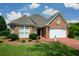 Charming brick home featuring manicured landscaping, a two-car garage and a welcoming front entrance at 2392 Ivy Mountain Dr, Snellville, GA 30078