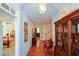 Bright hallway featuring hardwood floors, white walls, and decorative furniture and swan at 2392 Ivy Mountain Dr, Snellville, GA 30078