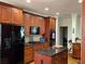 Eat-in kitchen featuring a granite island, cherry cabinets, and stainless steel appliances at 2392 Ivy Mountain Dr, Snellville, GA 30078