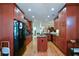 Spacious kitchen boasts wood cabinets, black appliances, and hardwood floors at 2392 Ivy Mountain Dr, Snellville, GA 30078