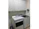 Bright laundry room with white cabinets and modern washer and dryer at 2392 Ivy Mountain Dr, Snellville, GA 30078