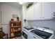 Well-equipped laundry room with modern washer and dryer, ample cabinet space, and stylish accents at 2392 Ivy Mountain Dr, Snellville, GA 30078