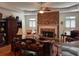 Spacious living room featuring a fireplace, ceiling fan, and built in bookcase at 2392 Ivy Mountain Dr, Snellville, GA 30078