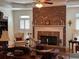 Cozy living room with fireplace, built-in bookshelves, and plantation shutters at 2392 Ivy Mountain Dr, Snellville, GA 30078
