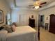 Bedroom featuring tray ceilings, a ceiling fan, and neutral-toned furnishings at 2392 Ivy Mountain Dr, Snellville, GA 30078