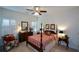 Traditional main bedroom featuring a four-poster bed, ceiling fan, and bright natural light from shuttered windows at 2392 Ivy Mountain Dr, Snellville, GA 30078