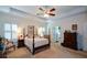 Comfortable main bedroom features a four-poster bed, neutral tones, and a private en-suite bathroom at 2392 Ivy Mountain Dr, Snellville, GA 30078