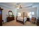 Serene primary bedroom features a four-poster bed, plush carpeting, and ample natural light at 2392 Ivy Mountain Dr, Snellville, GA 30078