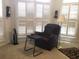 Office with shutter blinds, easy chair and stand to relax and work at 2392 Ivy Mountain Dr, Snellville, GA 30078