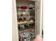 Organized pantry with wire shelving, filled with assorted food items and household goods at 2392 Ivy Mountain Dr, Snellville, GA 30078