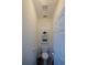 Well-lit powder room with a toilet, storage shelves, and neutral decor at 2392 Ivy Mountain Dr, Snellville, GA 30078
