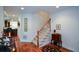 Open staircase with carpeted steps and wooden banister, adjacent to hardwood floors and neutral walls at 2392 Ivy Mountain Dr, Snellville, GA 30078