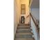 Carpeted staircase with white railing and decorative art and flowers on display at 2392 Ivy Mountain Dr, Snellville, GA 30078