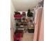 Organized storage shelving with various items and clothing at 2392 Ivy Mountain Dr, Snellville, GA 30078