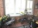 A cozy sunroom has brick walls, large windows, and seating areas at 2392 Ivy Mountain Dr, Snellville, GA 30078