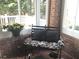 Bright sunroom with brick walls, comfortable seating, and natural light at 2392 Ivy Mountain Dr, Snellville, GA 30078