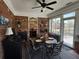 The sunroom with brick walls and a view of the backyard, offers a quiet space to relax or dine at 2392 Ivy Mountain Dr, Snellville, GA 30078