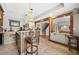 Cozy bar area featuring tile flooring, pendant lighting, and custom cabinets, with access to other areas of the house at 2431 Valhalla Ne Dr, Atlanta, GA 30345