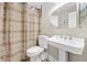 Cozy bathroom with classic fixtures, including a pedestal sink and decorative shower curtain at 2431 Valhalla Ne Dr, Atlanta, GA 30345