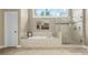 Bright bathroom features a soaking tub with tiled surround, a walk-in shower, and a large window at 2431 Valhalla Ne Dr, Atlanta, GA 30345