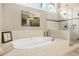 Elegant bathroom with soaking tub, frameless shower, and a large window for natural light at 2431 Valhalla Ne Dr, Atlanta, GA 30345