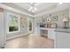 Bright bonus room featuring tile flooring, a ceiling fan, a built-in desk, and access to the backyard at 2431 Valhalla Ne Dr, Atlanta, GA 30345