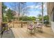 Outdoor deck features a dining table, grill, bench seating, and views of the landscaped backyard at 2431 Valhalla Ne Dr, Atlanta, GA 30345