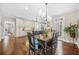 Bright dining area featuring hardwood floors, an elegant chandelier, and a view into the kitchen and access to the backyard at 2431 Valhalla Ne Dr, Atlanta, GA 30345