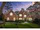 Charming brick home featuring manicured lawn and mature landscaping during twilight at 2431 Valhalla Ne Dr, Atlanta, GA 30345