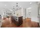 Open concept kitchen featuring a dark island with countertop seating and pendant lighting at 2431 Valhalla Ne Dr, Atlanta, GA 30345