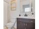 Modern bathroom featuring a dark vanity, subway tile backsplash, and stylish gold shelving at 2521 Capella Sw Cir, Atlanta, GA 30331